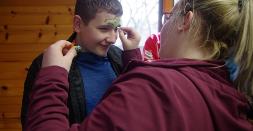 A camper gets his face painted