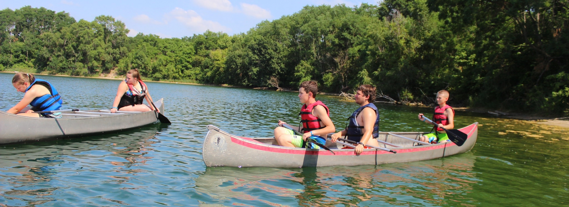 Two canoes practice skills on the Kitaki lake
